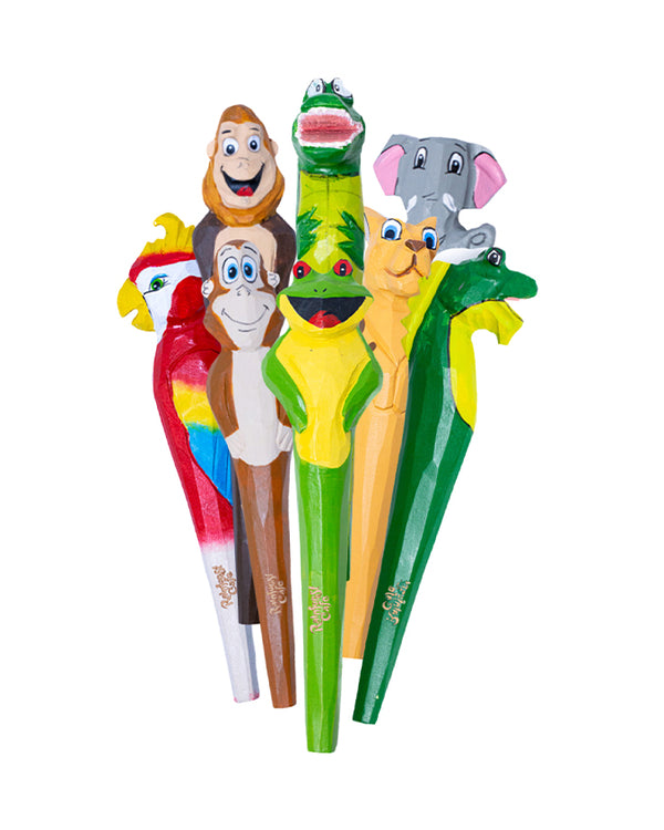 A collection of colorful pens standing upright in front of a white background, with carved and painted animal heads on the top and cursive text at the bottom reading "Rainforest Cafe". There is a crocodile, elephant, parrot, gorilla, monkey, jaguar, iguana, and frog.