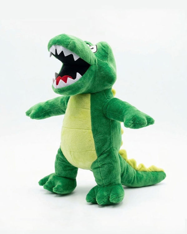 A green plush crocodile toy with an open mouth showing white and red teeth, standing against a plain white background.