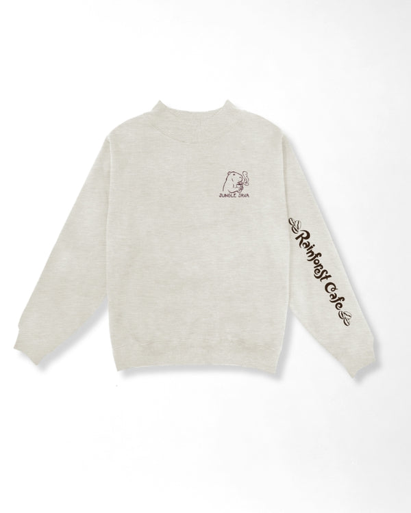 A light beige crewneck sweatshirt with a small graphic of capibara with a cup of coffee on the left chest and 'Rainforest Cafe' text printed in black along the right sleeve, shown against a plain white background.