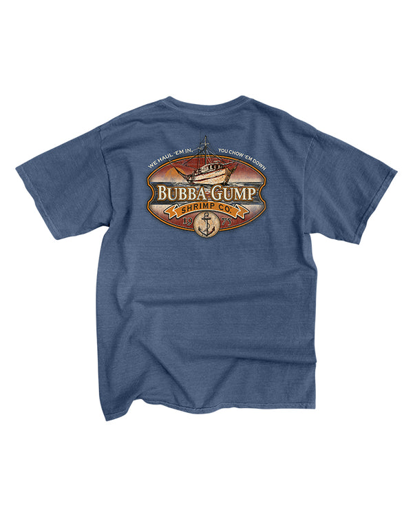 A backside view of a crewneck T-shirt with a rustic graphic of a ship sailing at sea in the sunset, reading "Bubba Gump Shrimp Co." in the middle with an anchor inside a beige circle. On the top of the graphics, there are words " We haul'em in, you chow 'em down." The background is plain white.