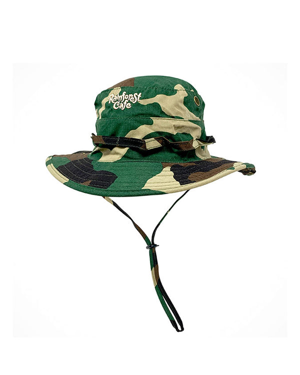 A camouflage print safari/bucket hat with an adjustable chin strap, and the Rainforest Cage logo embroidered on the top. The background is plain white.