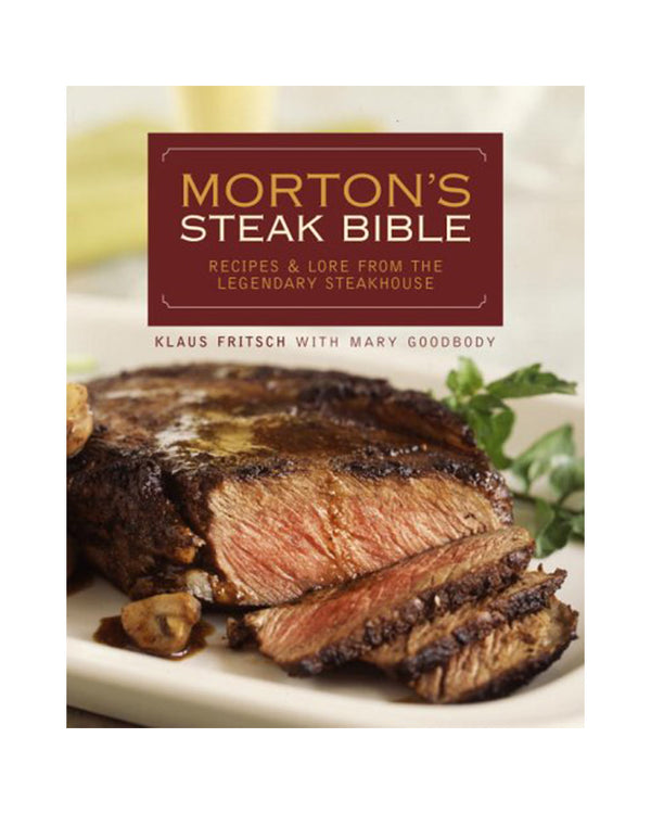 The front of a cookbook featuring an image of a plated steak and the title "MORTON'S STEAK BIBLE", "RECIPES & LORE FROM THE LEGENDARY STEAKHOUSE", "KLAUS FRITSCH WITH MARY GOODBODY". The background is plain white.
