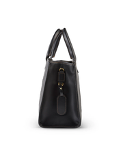 side view. A sleek black leather handbag with a side tag and buckle detail, featuring a glossy finish and meticulous stitching, presented against a white background