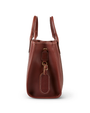 side view. A sleek brown leather handbag with a side tag and buckle detail, featuring a glossy finish and meticulous stitching, presented against a white background