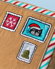 Embroidered patches on a fabric with a envelope design