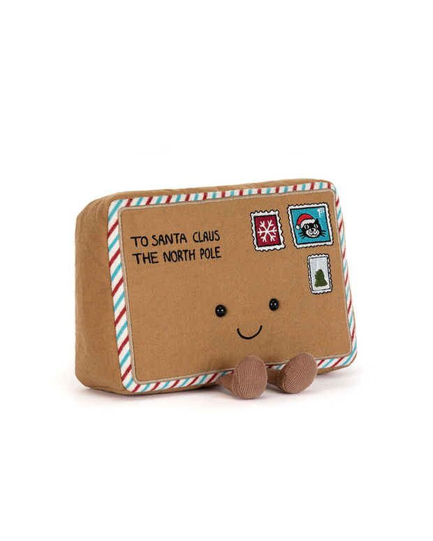 Stuffed toy resembling an envelope addressed to Santa Claus with stamps on a white background