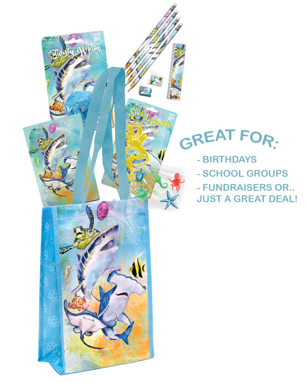 A collection of themed party supplies featuring aquatic animals and designs. The set includes a gift bag with illustrations of sharks and other sea creatures, alongside matching notebook, eraser, and pencils with similar aquatic motifs. The colors are vibrant with a predominant use of blues and greens, evoking an underwater scene.