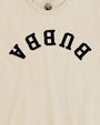 Close-up of an off-white crewneck t-shirt featuring the word 'BURGA' printed in large black varsity-style letters across the chest.