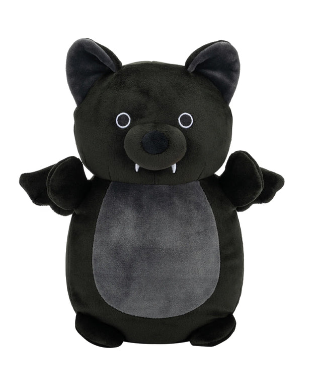 A plush toy resembling a black bat with prominent ears, round eyes, and a small protruding nose. The bat has a lighter grey belly and an open-mouthed smile with two small white teeth visible. 