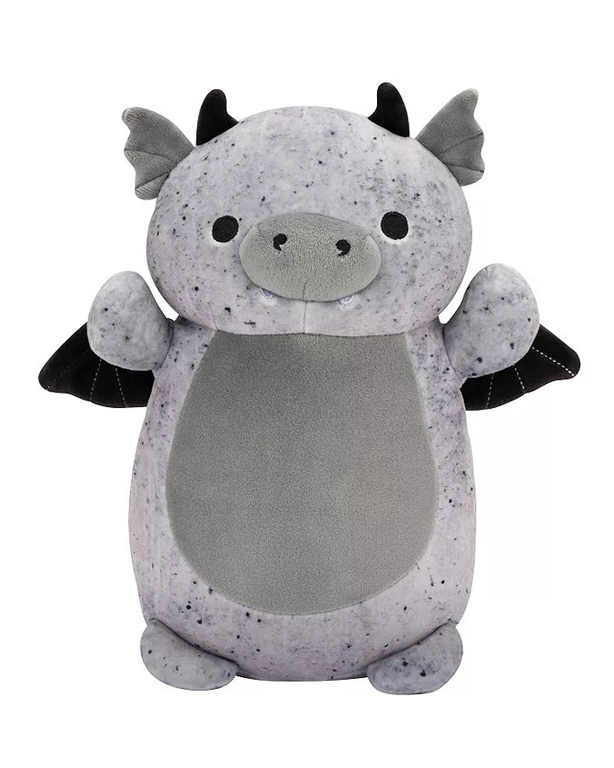 A plush toy resembling a mythical dragon creature, primarily in a light grey color with darker grey speckles. The toy has small, pointed ears, two tiny horns on the top of its head, wings on its back, and a friendly facial expression with two round eyes and a smiling mouth. The belly of the toy is a plain light grey oval shape that contrasts with the speckled texture of the rest of its body.