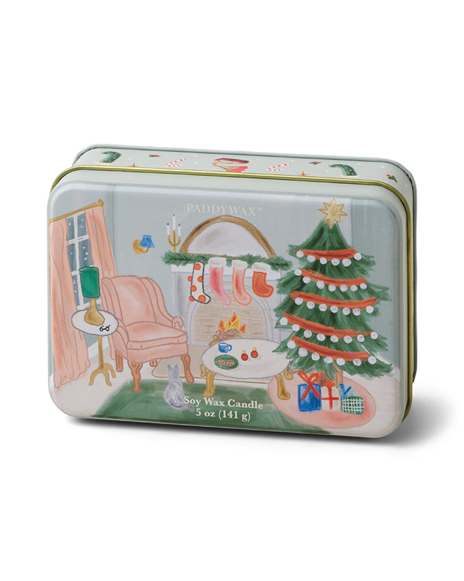 A rectangular soy wax candle tin with a festive Christmas design. The illustration on the tin features a cozy room scene with a decorated Christmas tree, gifts, and an armchair next to a window. The word ‘HOLIDAY’ is prominently displayed above the tree in stylized lettering. The candle is labeled as 5 oz (141 g).