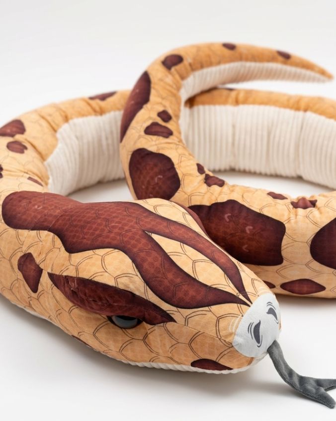 Plush snake toy with brown and beige pattern on a white background
