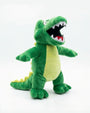 A green plush crocodile toy with a wide-open mouth showing white and red teeth, set against a plain white background.