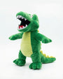 A green plush crocodile toy with an open mouth showing white and red teeth, standing against a plain white background.
