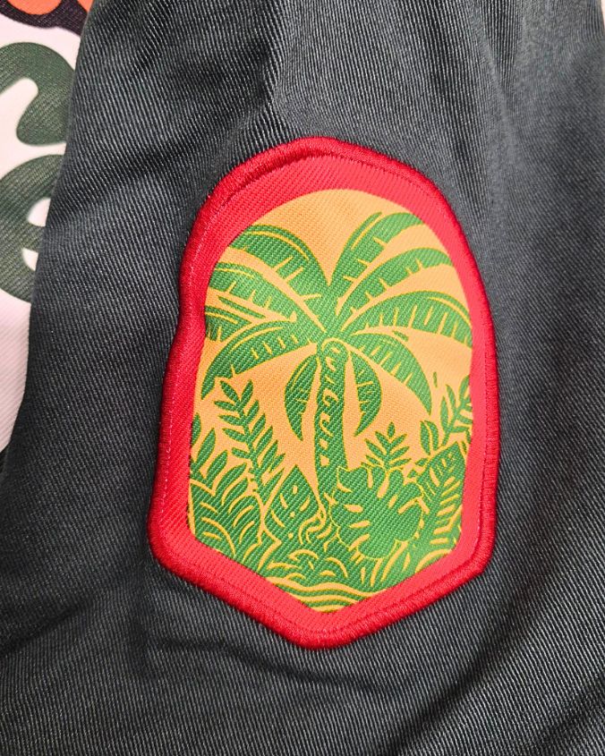 Jacket with a tropical palm tree patch on a dark background