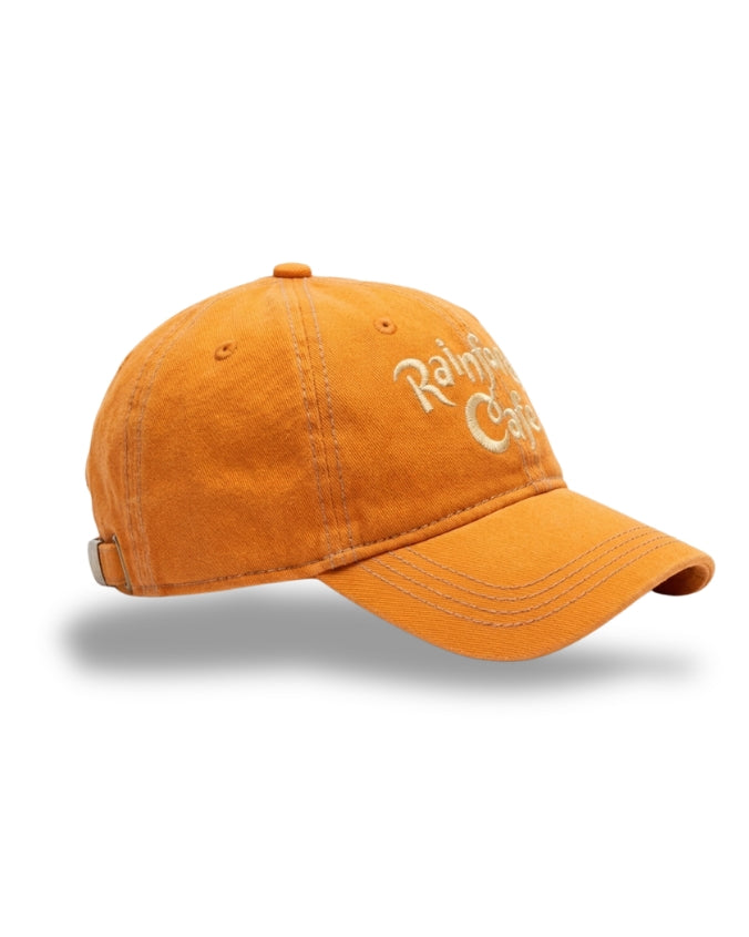 An orange cotton baseball cap with white embroidered text reading 'Rainier Cafe' on the front, shown on a clean white background with a soft drop shadow.