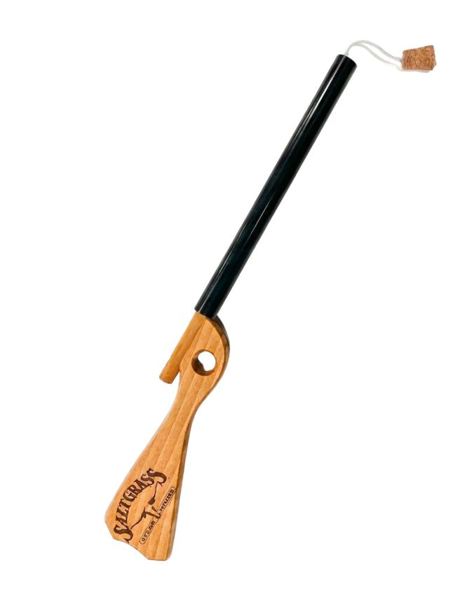 Wooden and black cat toy with a string on a white background
