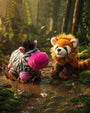 Two plush toys, a zebbo and a red pandion standing in a forest setting.