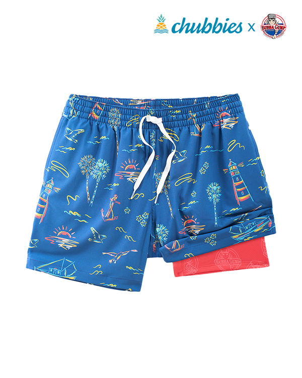 A full view of a pair of blue elastic drawstring waistband shorts with a colorful neon pattern that includes ocean paraphernalia including palm trees, sailboats, lighthouses, etc. One side is revealing a pink lining with Bubba Gump Shrimp logos under the shorts. The top right corner of the image features the Chubbies and a Bubba Gump Shrimp Logo, against a white background.
