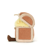 A side-view of a plush toy treasure chest with feet, sitting against a white background, opened and revealing a fluffy yellow interior with colorful coins embedded in it. 