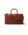 A brown leather duffle bag with a padded shoulder strap, and a padded handle. There is an oval shaped patch at the top. The background is plain white.